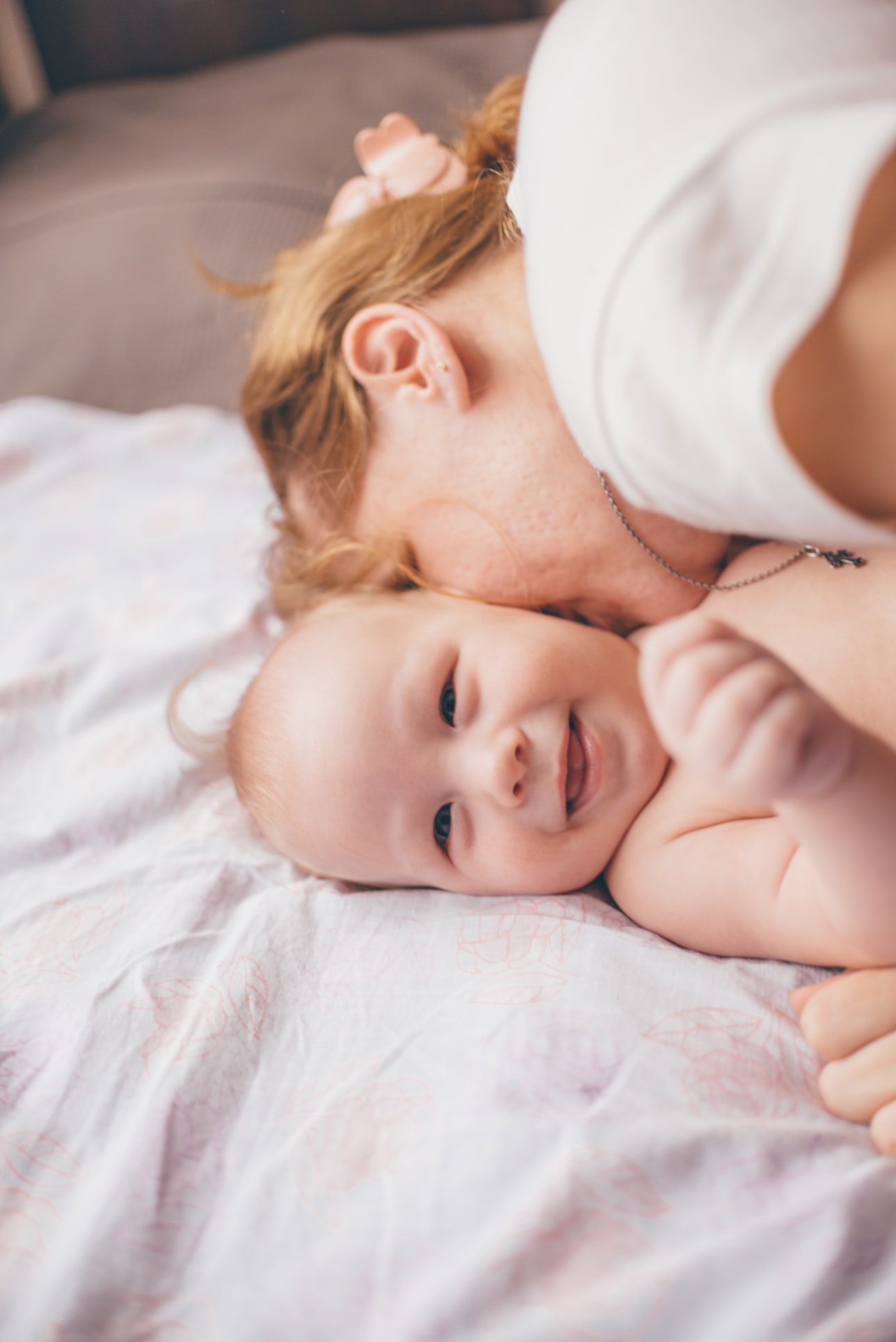 Baby getting kisses from mom